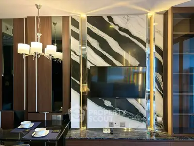 Luxurious living room with marble accent wall and modern lighting
