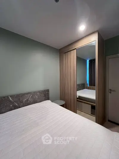 Modern bedroom with sleek design and built-in wardrobe