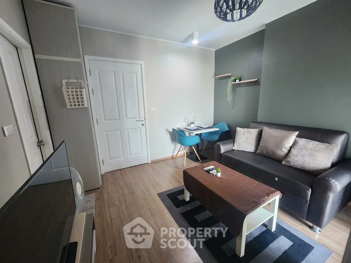 Cozy living room with modern decor, featuring a comfortable sofa and dining area.