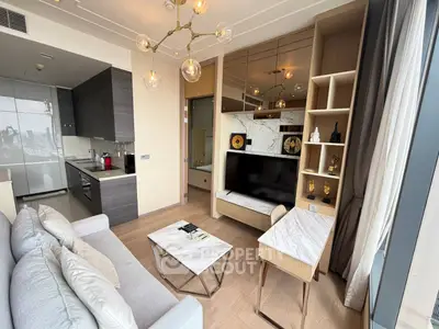 Modern living room with stylish decor and open kitchen layout in a high-rise apartment.