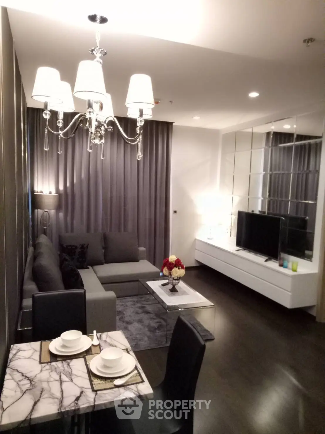 Luxurious modern living room with elegant chandelier and stylish decor