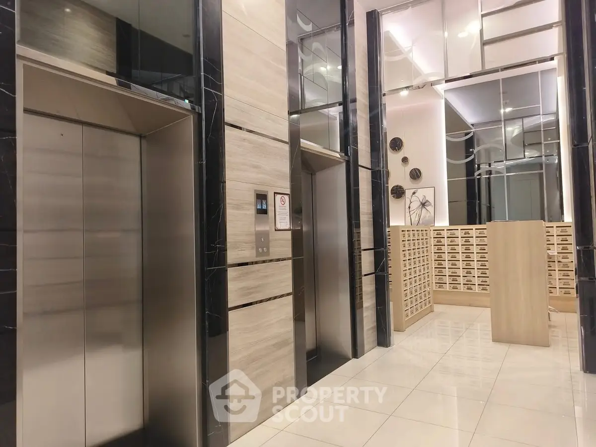 Modern building entrance with sleek elevators and mailboxes