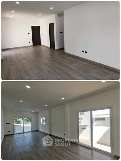 Spacious modern living room with large windows and sleek wooden flooring.