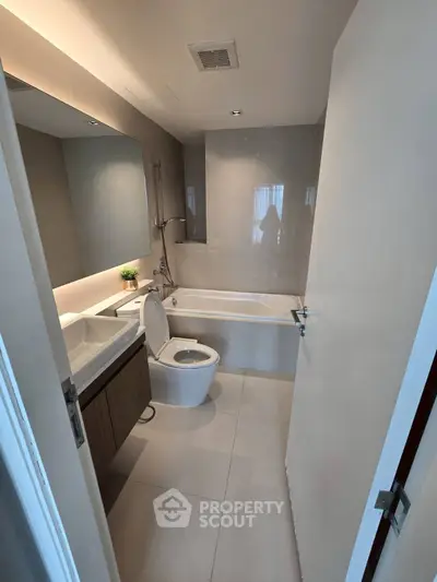 Modern bathroom with sleek design and bathtub in a contemporary apartment.