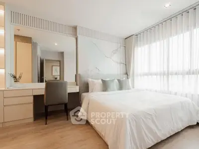 Elegant bedroom with natural light and modern decor, featuring a cozy bed and stylish vanity area.