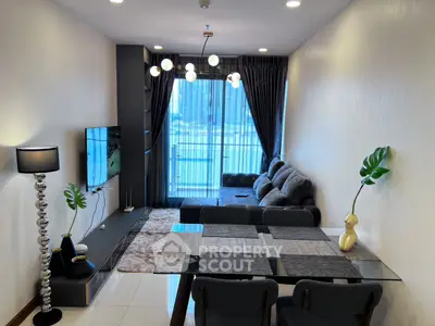 Modern living room with stylish decor and large window offering natural light.