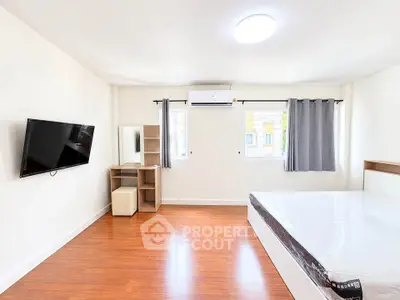 Spacious bedroom with modern furnishings and natural light