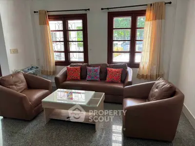 Cozy living room with stylish furniture and large windows offering natural light.