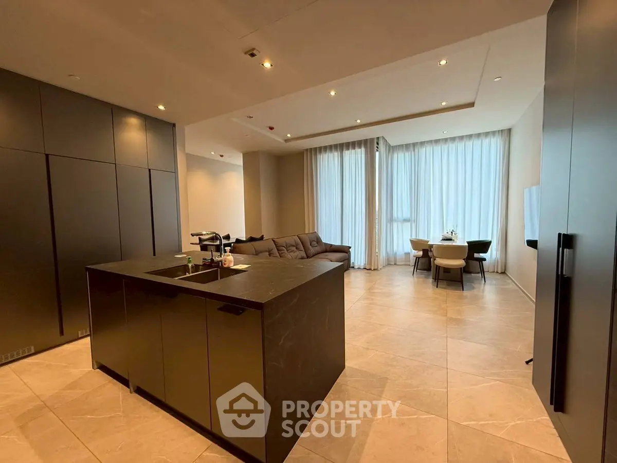 Luxurious open-plan living room with modern kitchen island and elegant dining area