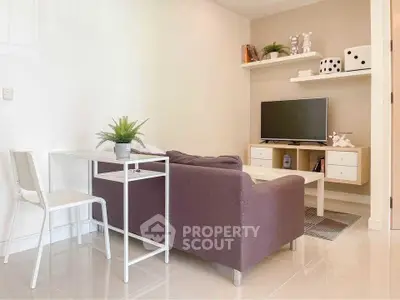Modern living room with sleek furniture and wall-mounted TV, perfect for cozy relaxation.
