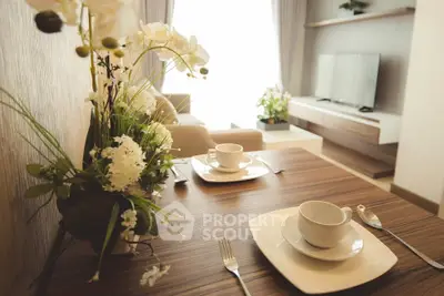 Elegant living room with modern decor and dining setup, featuring a cozy ambiance and stylish furniture.