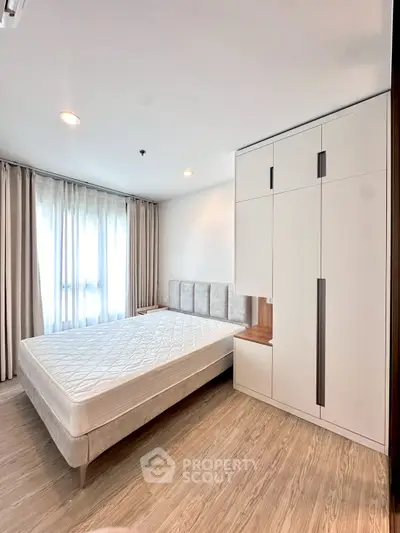 Spacious bedroom with modern design and ample natural light