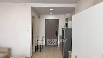 Modern apartment entrance with compact kitchen and sleek design
