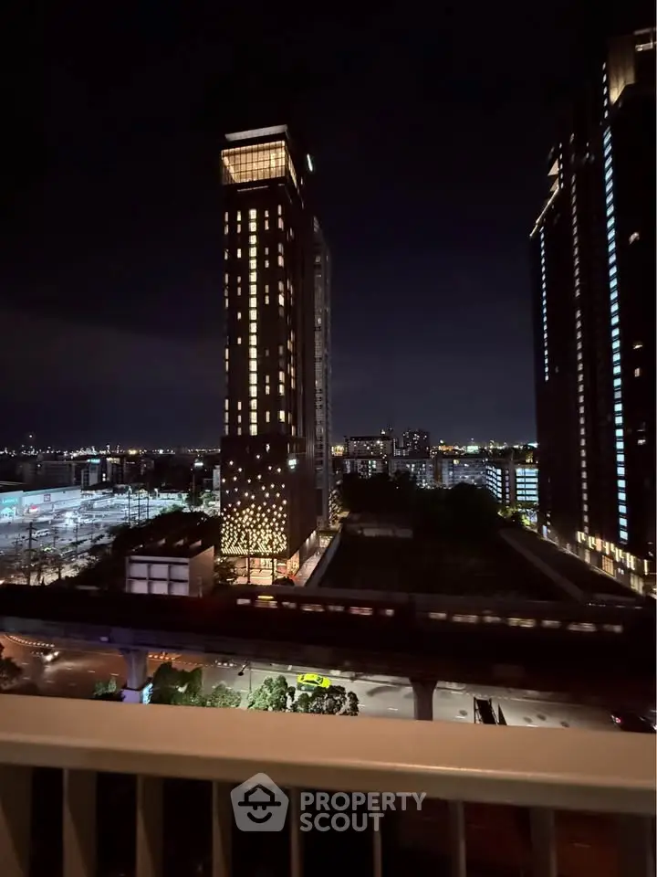 Stunning night view of modern high-rise buildings with cityscape backdrop.