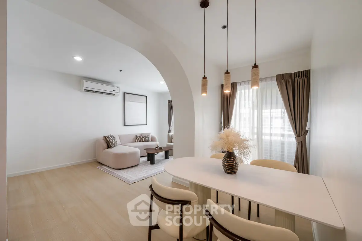 Modern open-plan living and dining area with stylish decor and natural light.