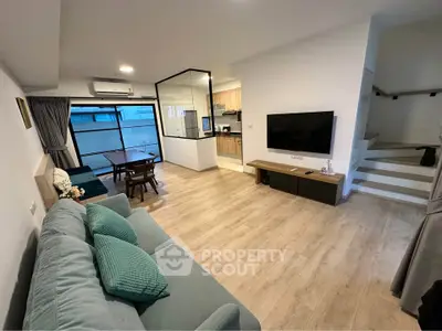 Modern living room with open layout, stylish furniture, and natural light, perfect for family gatherings.