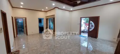Spacious living room with elegant marble flooring and stylish ceiling fan