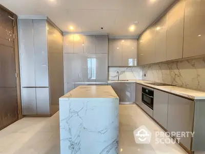 Sleek modern kitchen with marble countertops, built-in stainless steel appliances, and ample cabinet space, perfect for culinary enthusiasts.