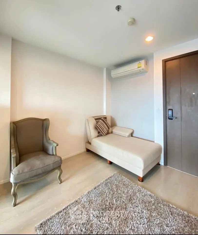 Spacious living room with elegant furniture and modern decor in a cozy apartment.