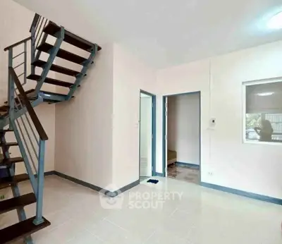 Modern duplex interior with sleek staircase and bright open space, perfect for contemporary living.