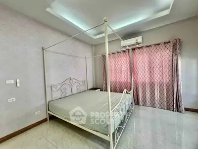 Spacious bedroom with elegant four-poster bed and modern decor