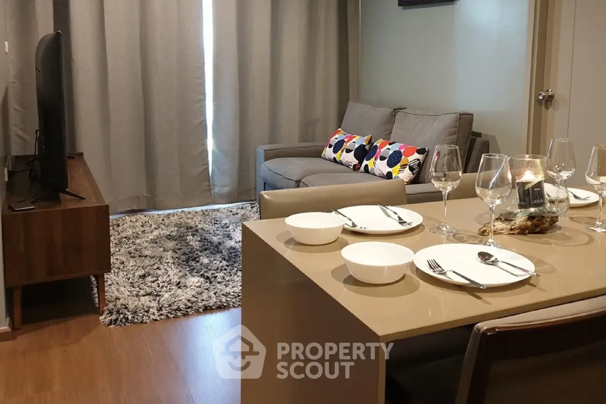 Modern living room with cozy seating and elegant dining setup in a stylish apartment.