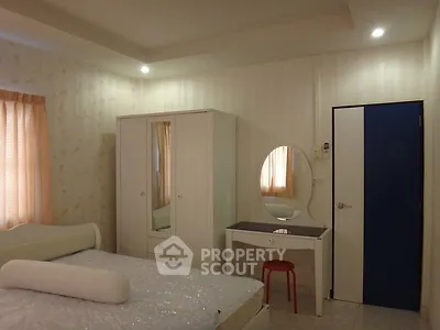 Cozy bedroom with modern furniture and soft lighting, perfect for relaxation.