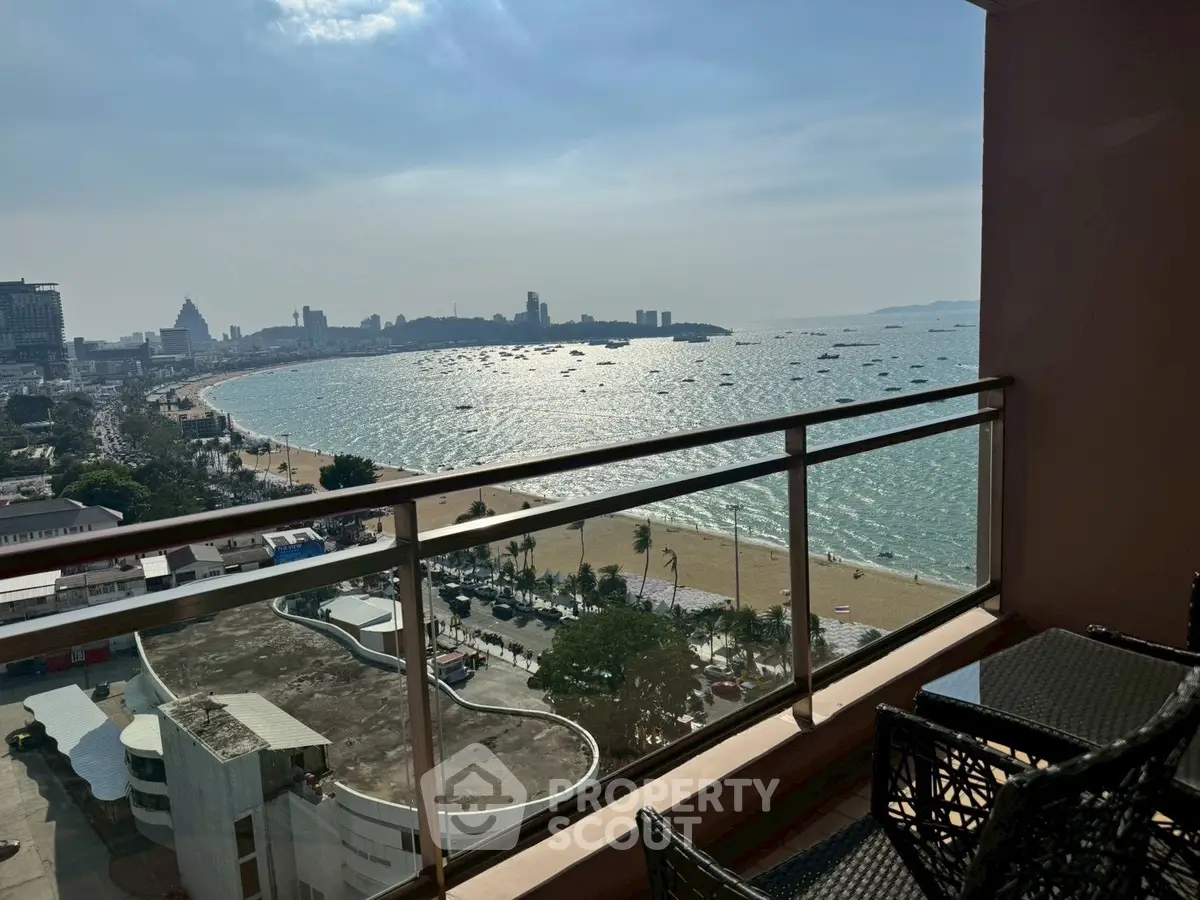 Stunning beachfront balcony view overlooking the ocean and city skyline, perfect for relaxation and enjoying sunsets.