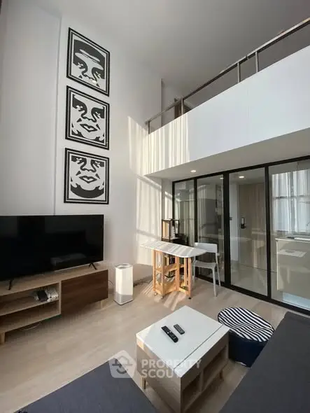 Modern loft-style living room with high ceilings and stylish decor