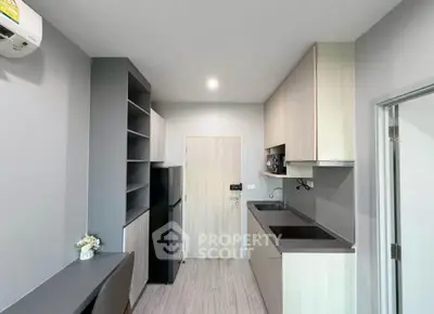 Modern kitchen with sleek cabinetry and built-in appliances in a compact layout.
