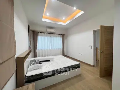 Modern bedroom with stylish ceiling lights and wooden flooring