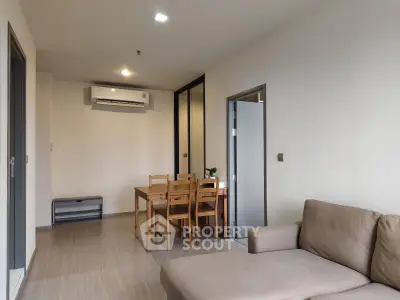 Modern living room with dining area and air conditioning in a stylish apartment.