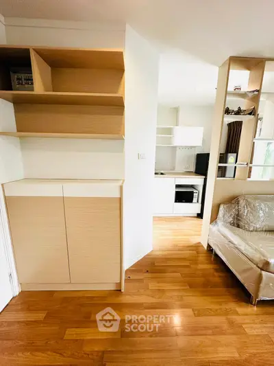 Modern apartment interior with wooden floors and open kitchen layout