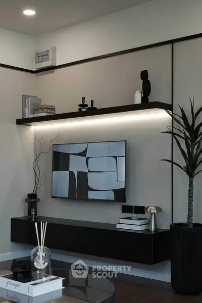Modern living room with sleek black furniture and abstract wall art