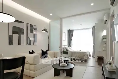 Modern open-plan living room with stylish decor and cozy bedroom area