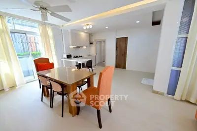Spacious open-plan living and dining area with modern kitchen and natural light.