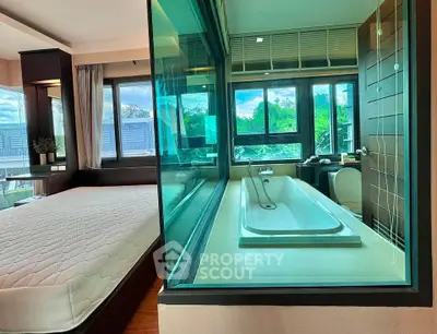 Modern bedroom with glass wall bathroom and scenic view