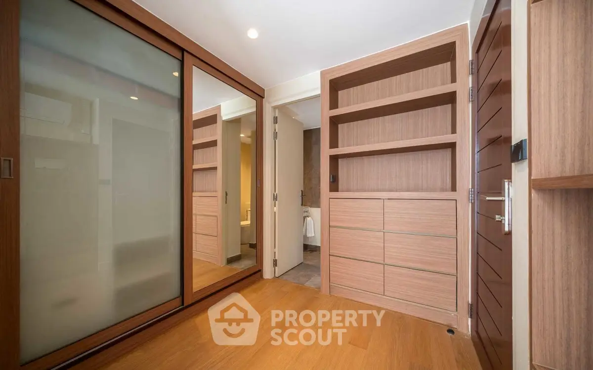 Spacious modern storage room with wooden flooring and built-in shelves