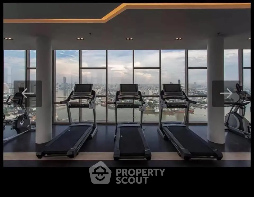 Luxurious high-rise gym with panoramic city views and modern fitness equipment.