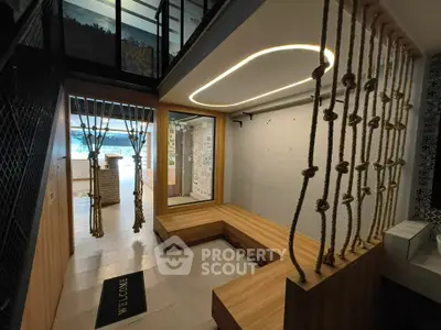 Modern lobby with unique rope design and wooden seating area, perfect for welcoming guests.