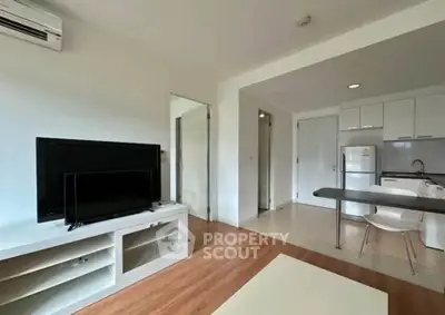 Modern open-plan living room with sleek kitchen and stylish decor