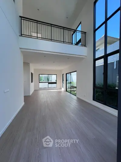 Spacious modern living room with high ceilings and large windows