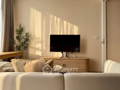 Cozy living room with modern TV setup and natural light