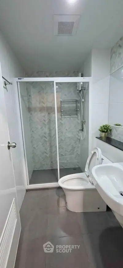 Modern bathroom with glass shower enclosure and sleek fixtures
