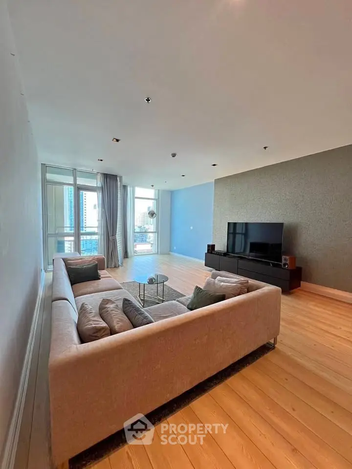 Spacious modern living room with large windows and stylish furniture