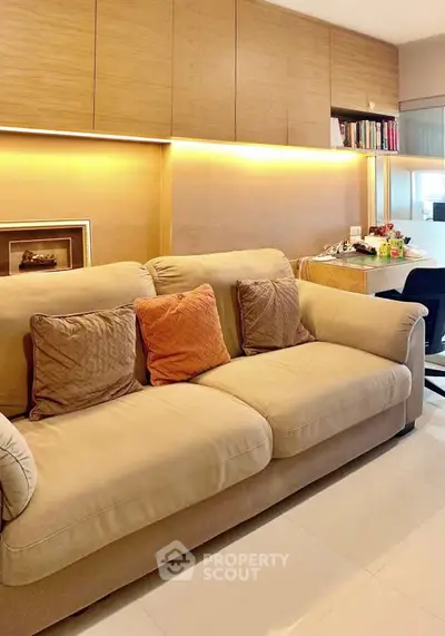 Cozy living room with plush sofa and warm lighting, perfect for relaxation.