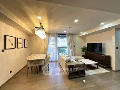 Spacious modern living room with elegant dining area and large TV setup, perfect for entertaining.