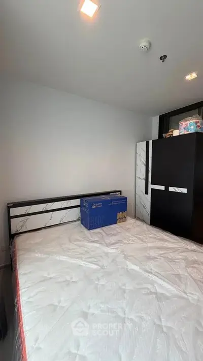 Modern bedroom with sleek wardrobe and comfortable bed in a stylish apartment.