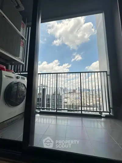 Stunning high-rise balcony view with city skyline and laundry area, perfect for urban living.