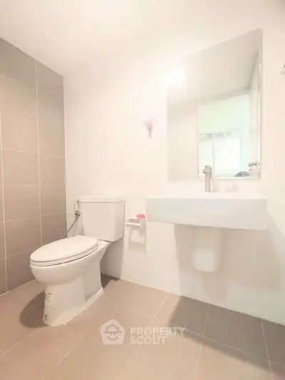 Modern bathroom with sleek fixtures and neutral tiles, perfect for a contemporary home.